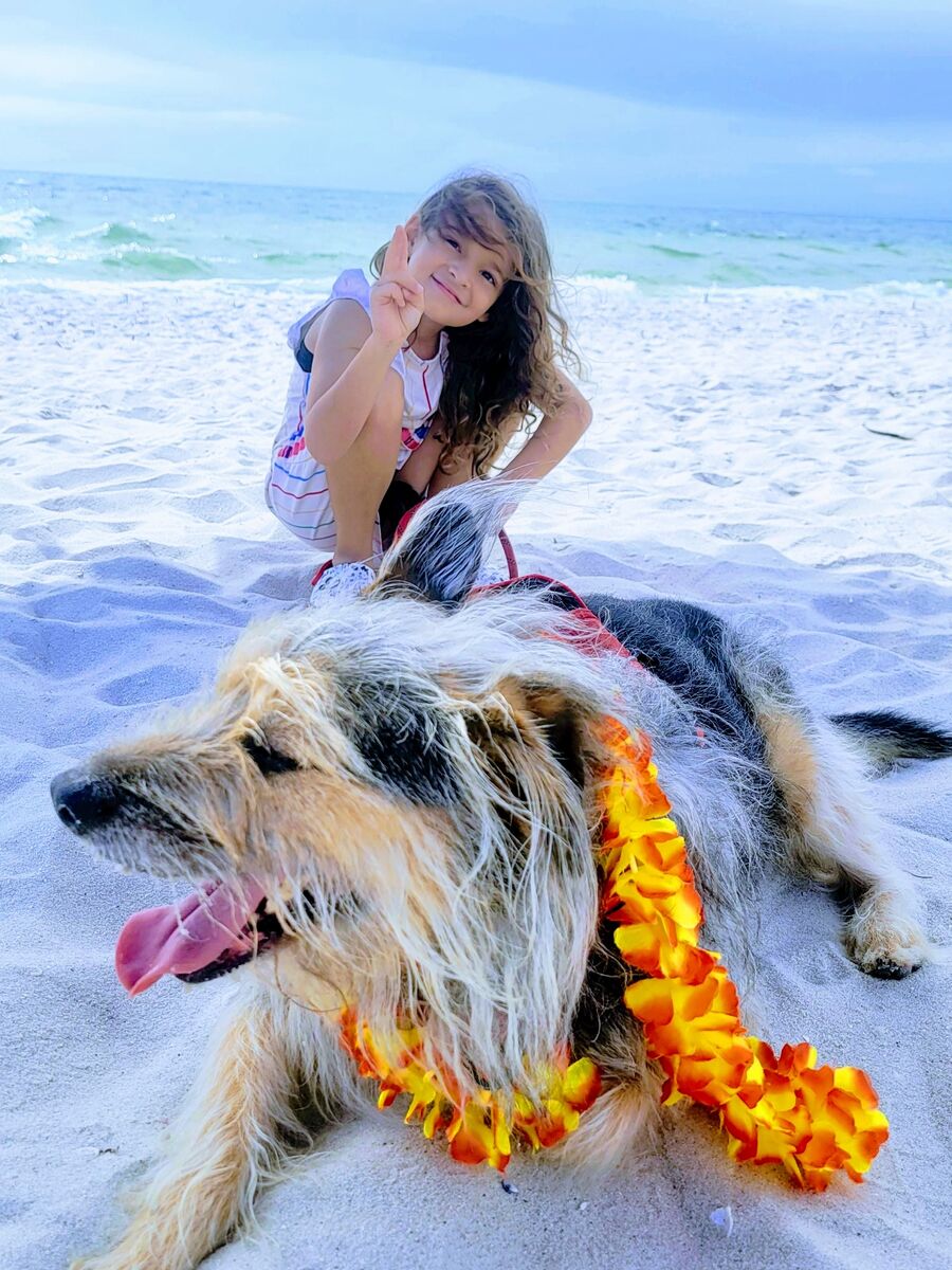 Nancy's daughter Francesca with their dog Lucky on the beach